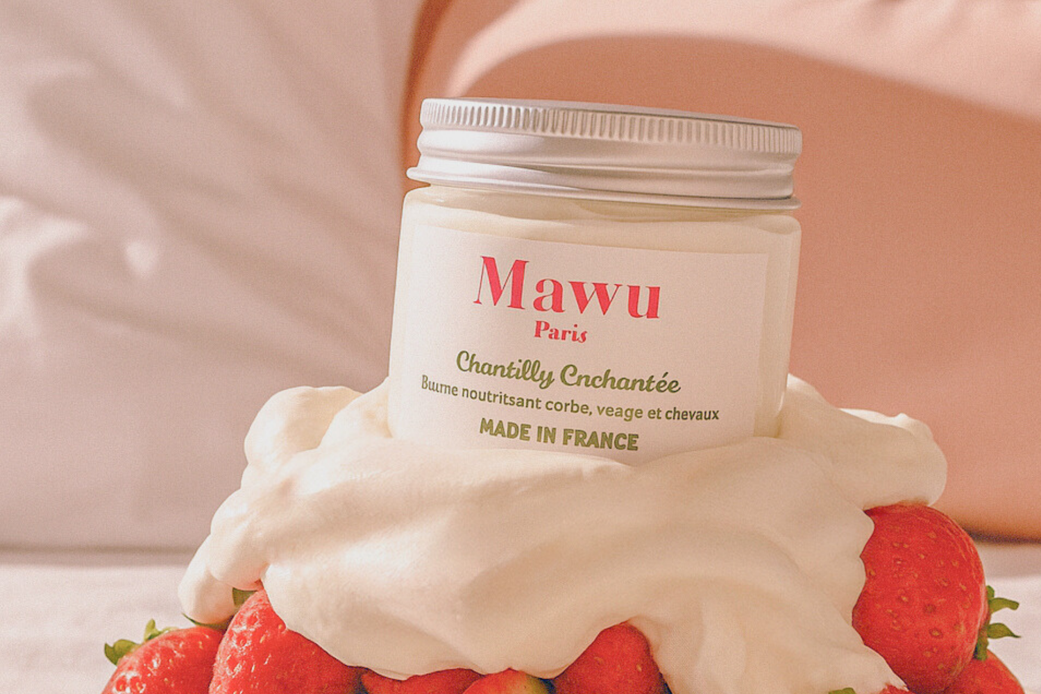 Fraises ecouvertes d'une couche de chantilly, avec un pot de Chantilly Enchantée de Mawu Paris posée au dessus.